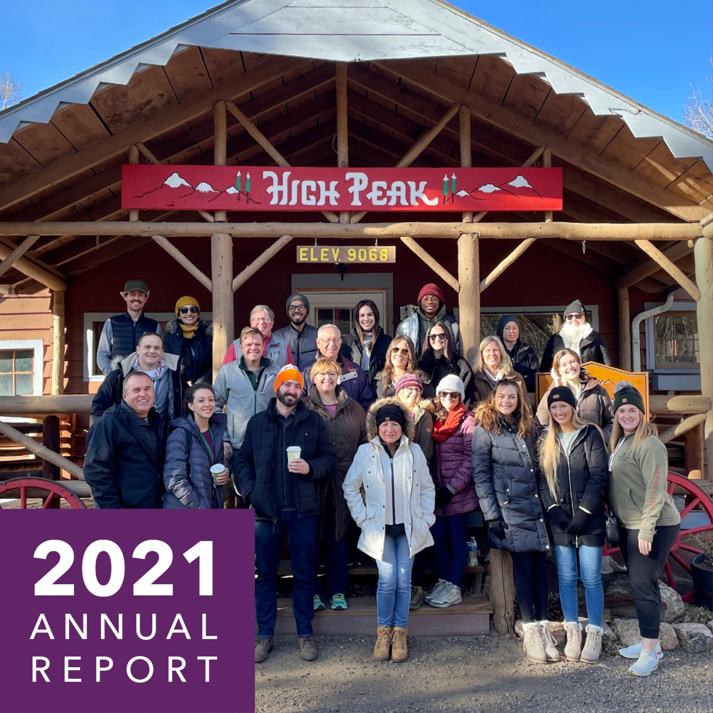 A group of people smile outside of a cabin. Text reads 2021 annual report.