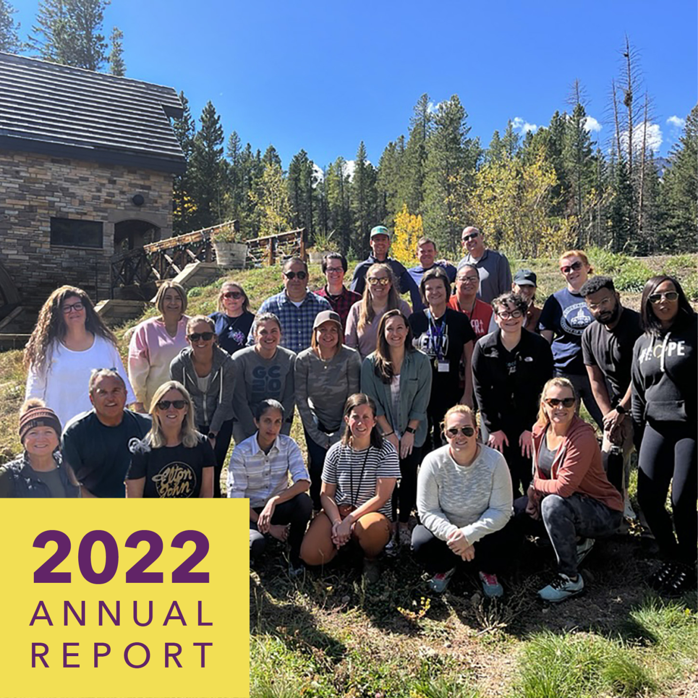 A group of people outside smile for the camera. Text reads alliance for hope international 2022 annual report