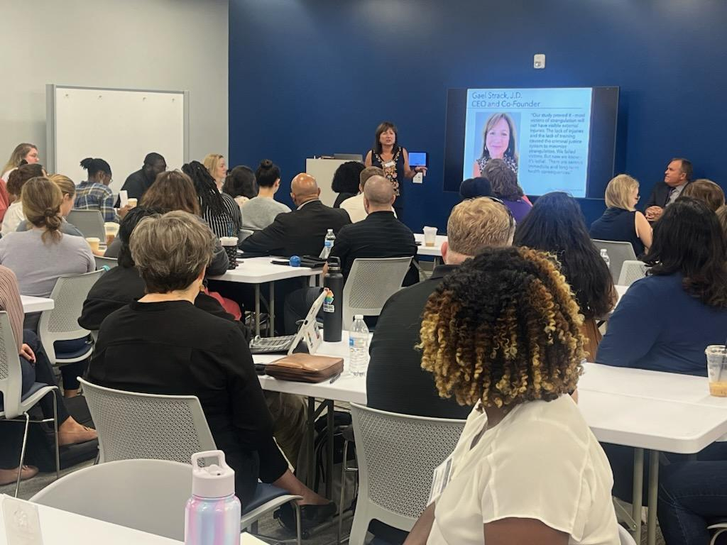 Woman in a suit speaking in training event
